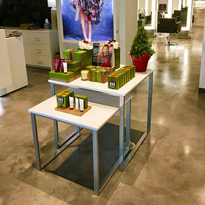 Retail nesting tables displaying hair and skin products in a beauty salon